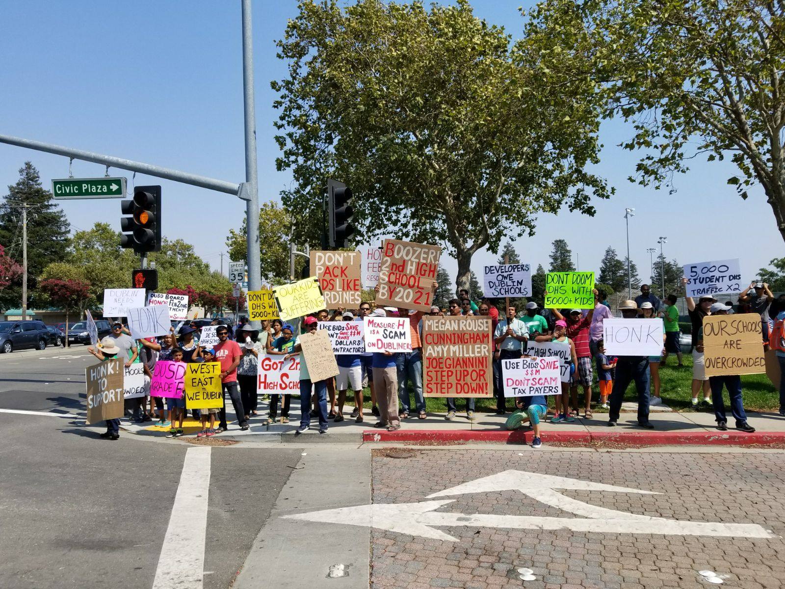 More than 200 Dublin residents rally with handmade signs outside a school board meeting demanding a second high school